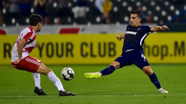 Luca in a navy Memphis 901 FC #9 kit kicking the ball.