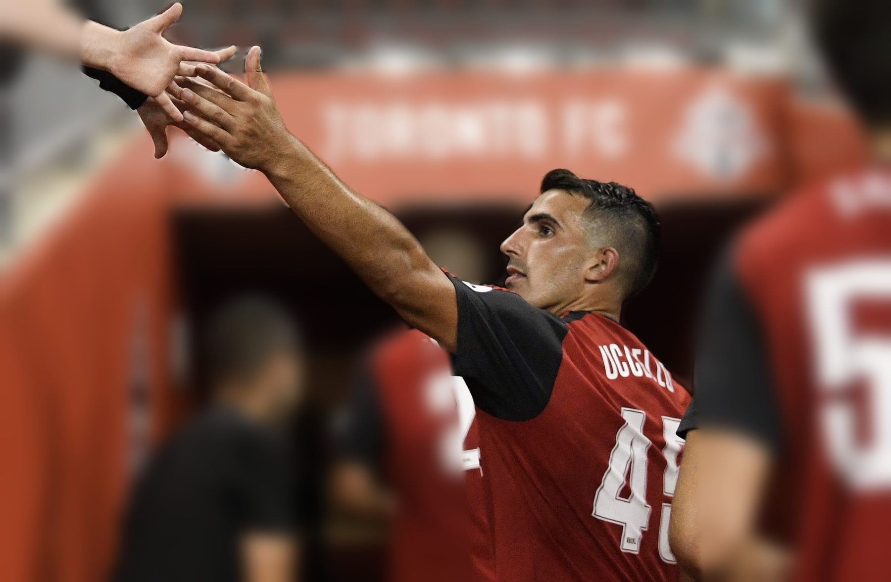 Luca high-fiving fans in the Toronto FC tunnel